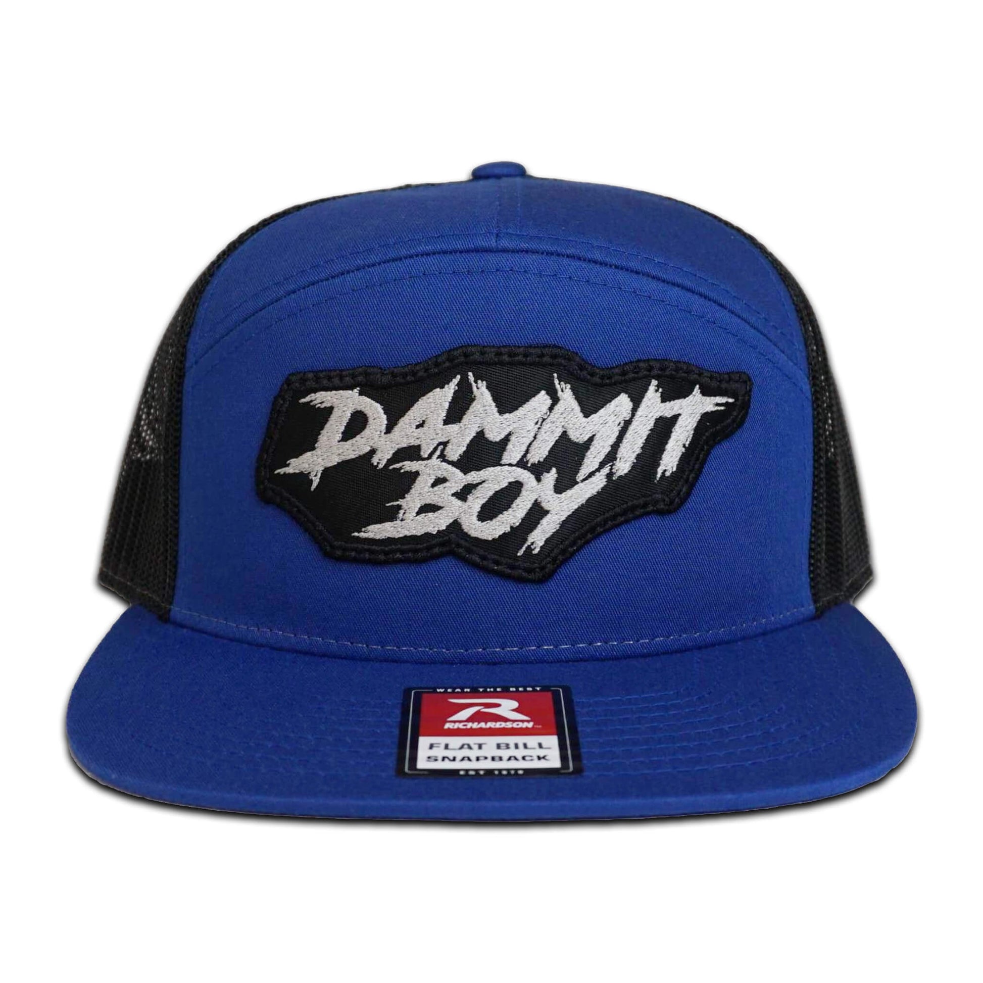 Shop the Project Torque “Dammit Boy” Flat Bill Snapback. One size fits all. Blue hat with black mesh back for breathability. This image shows the front of the snapback with the “Dammit Boy” logo.